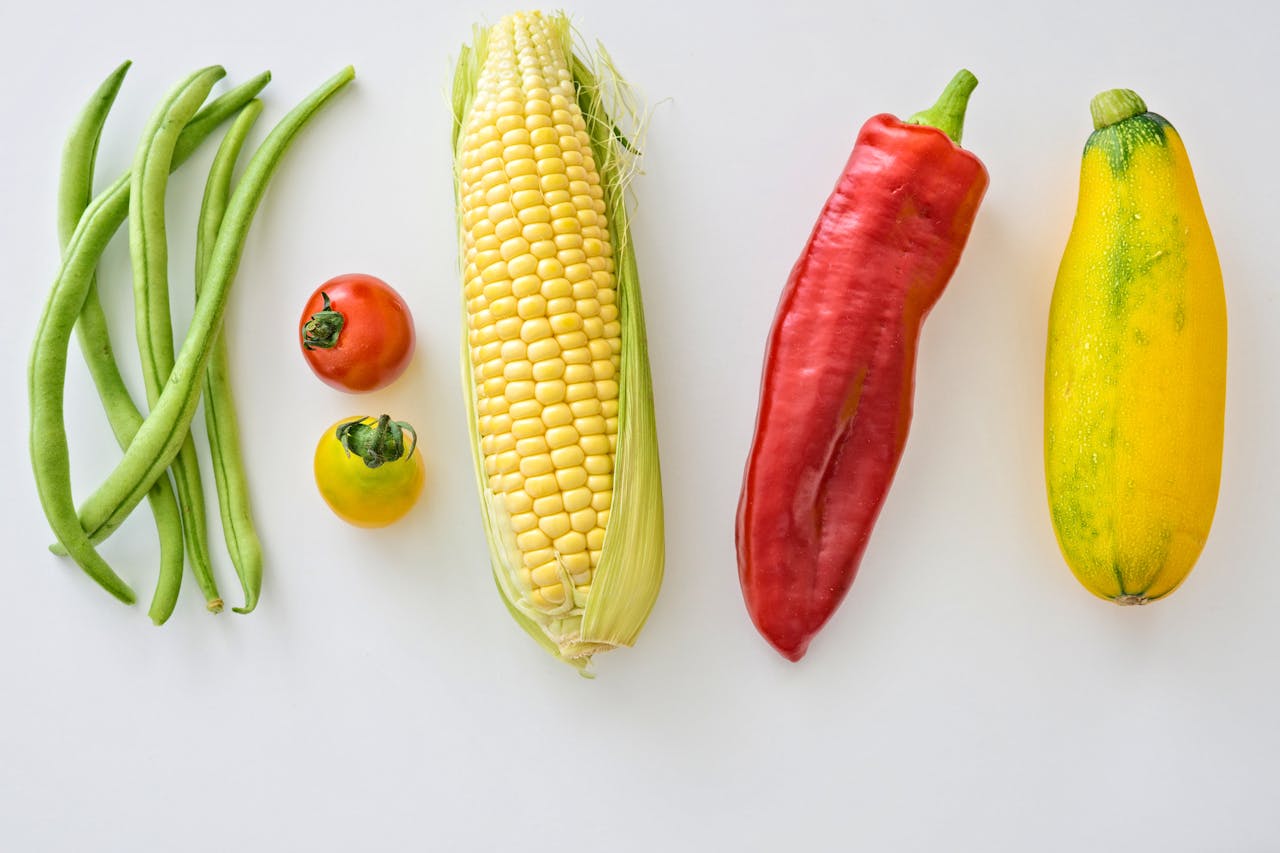 services-img A vibrant assortment of fresh vegetables including corn, peppers, beans, and tomatoes.
